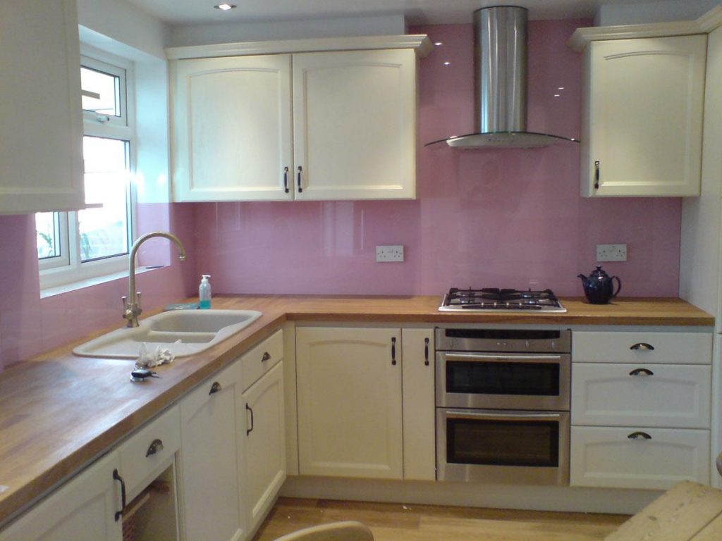 Pink painted glass kitchen backsplash tile idea
