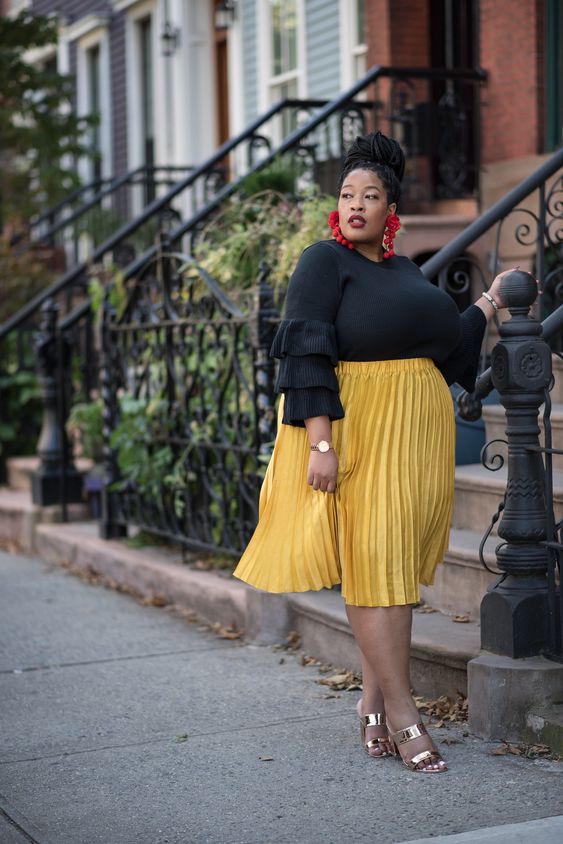 Yellow pleated skirt black top outfit