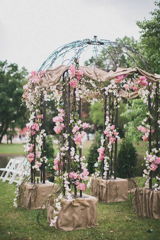 Wedding gazebo decorated with flowers and burlap