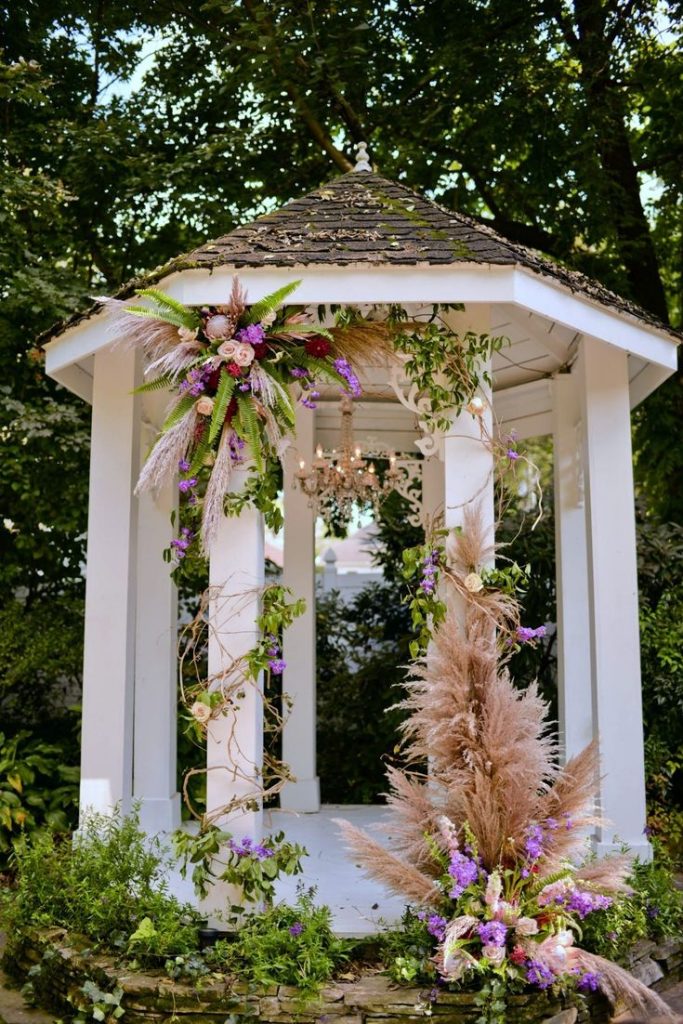 Wedding gazebo decorated with pampas grass and flowers