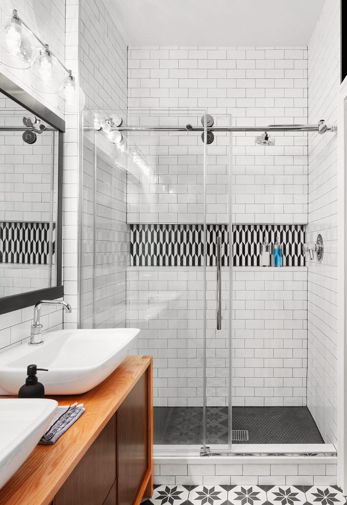 Bathroom design white subway tiles black grout masonry shelf