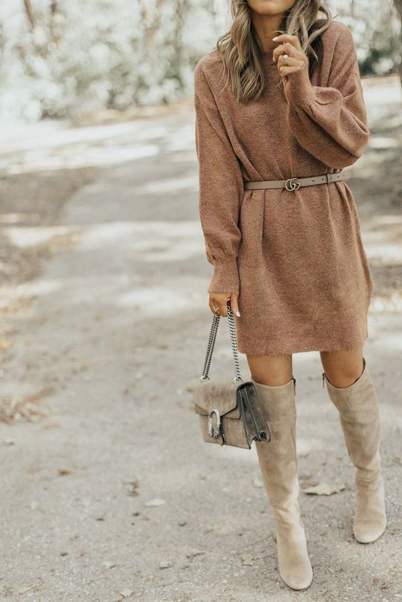 Sweater dress accessorized with belt and purse