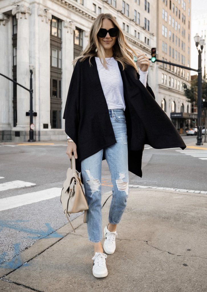 Black oversized poncho distressed skinny jeans white sneakers outfit idea