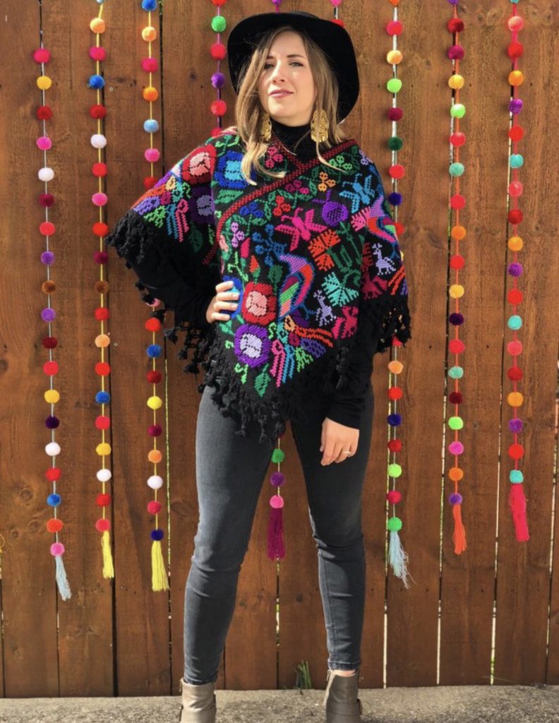 Poncho with traditional paterns black skinny jeans black fedora had outfit idea
