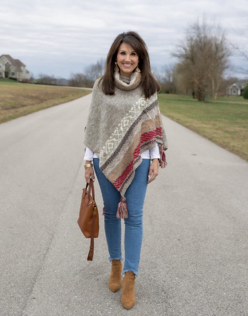 Poncho with traditional patterns blue skinny jeans outfit idea