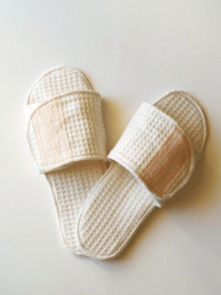 White fabric slippers to wear to a spa